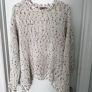 Sweater with Rainbow specks throughout. Asymmetrical hem at the bottom